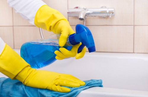 Cleaning staff sanitizing desks and shared office surfaces